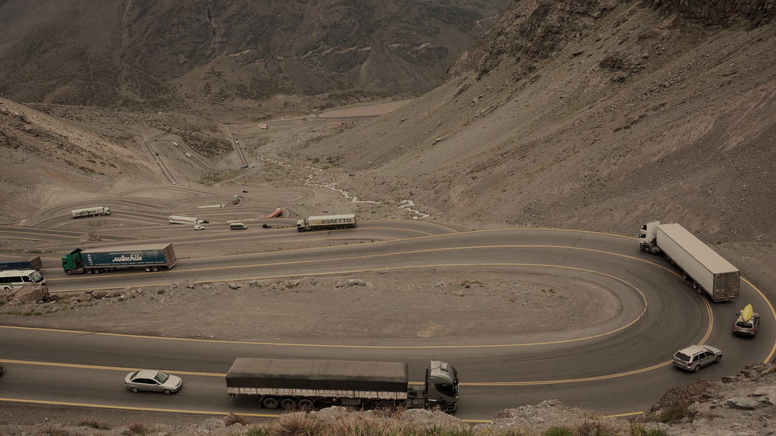 Heavy trucks on an Andean switchback.